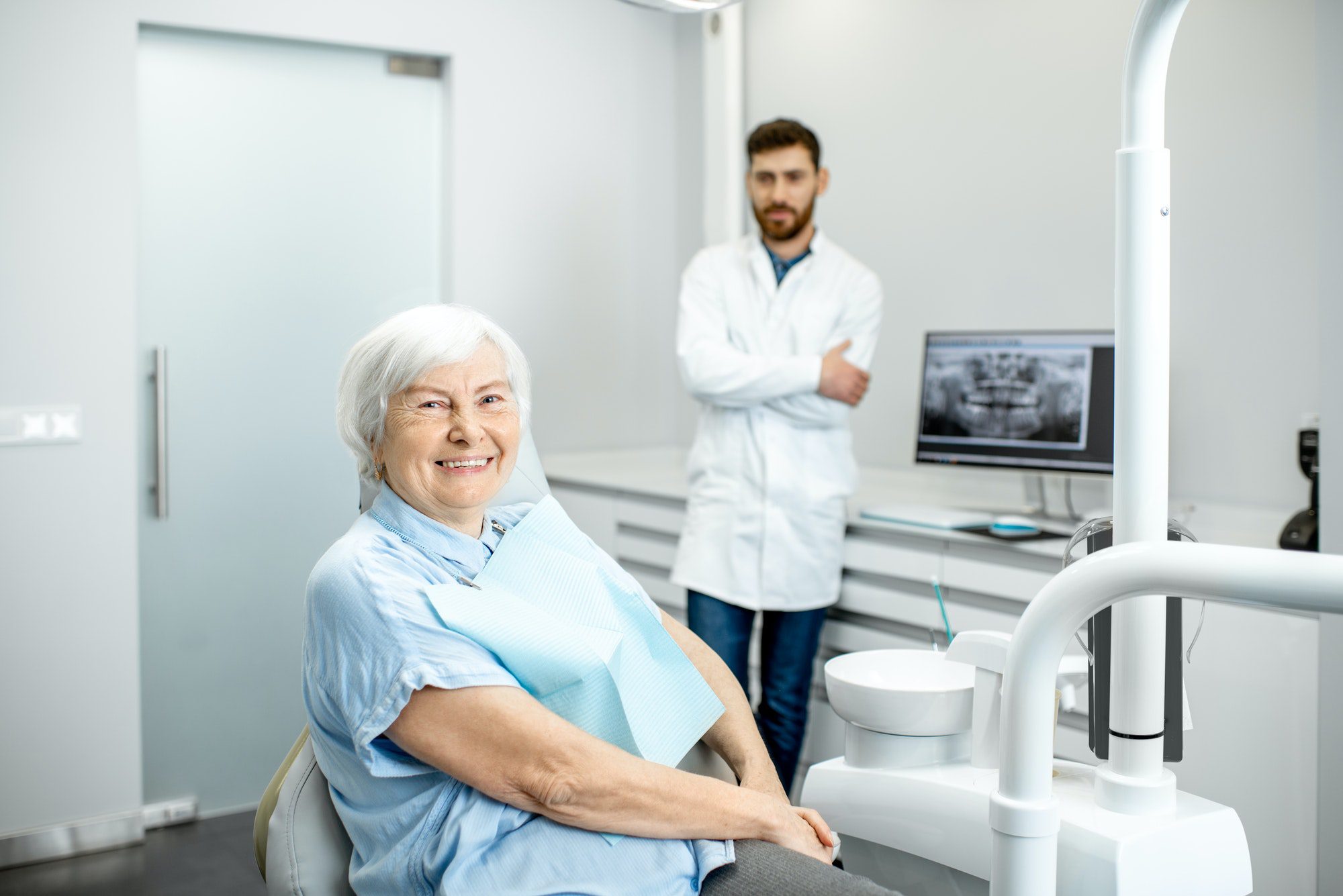 Elder woman with dentist in the dental office