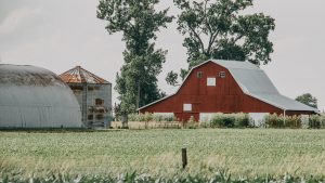 landscape view of a red barn on a farm in indiana e1638983029924