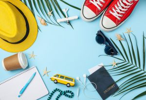 Travel accessories on blue background, top view. Travel blogger