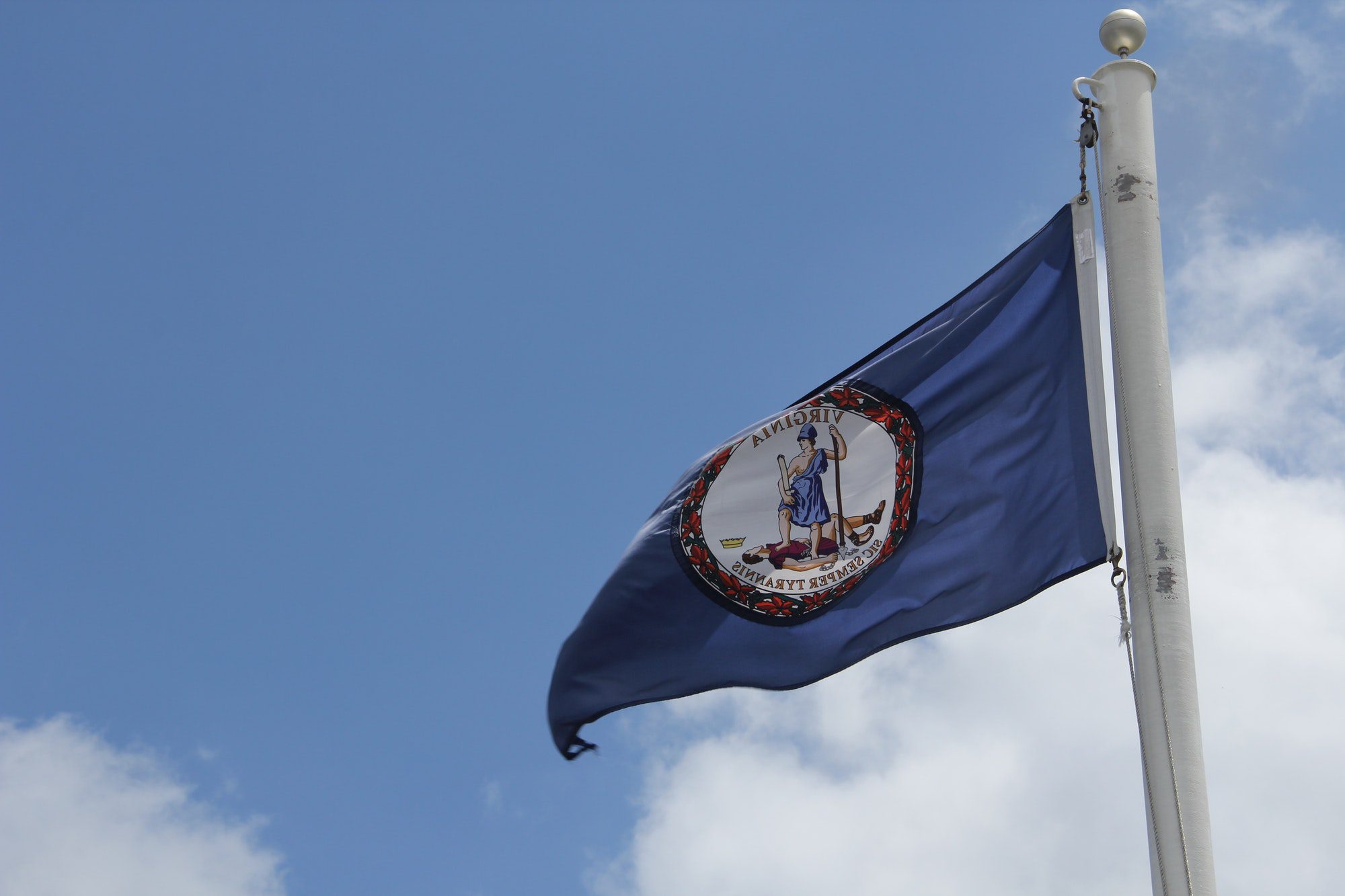 Virginia State flag. The official Seal against blue background of the Commonwealth of Virginia. USA